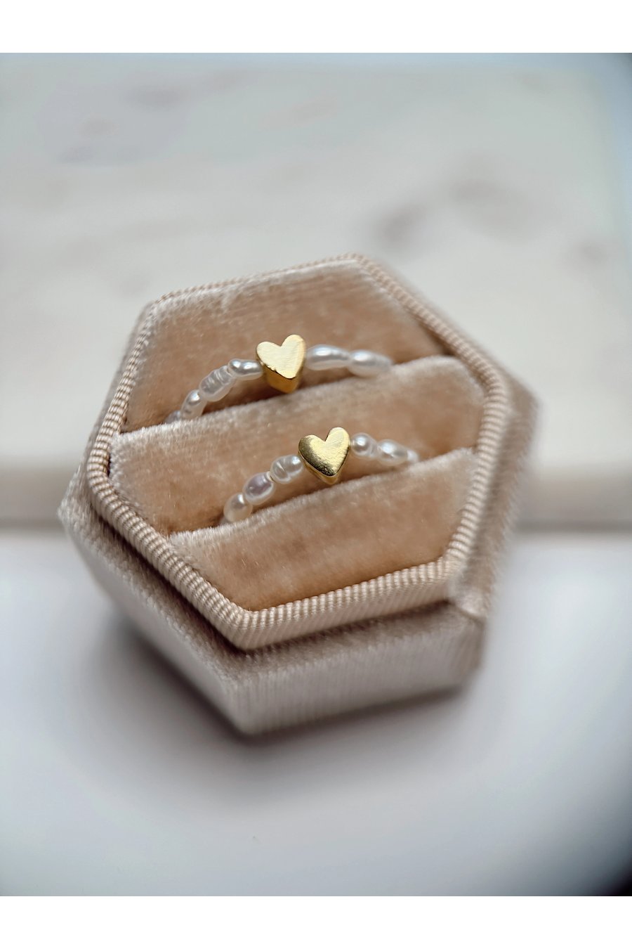 Handmade stretch ring with natural freshwater pearls and a gold-plated heart spacer