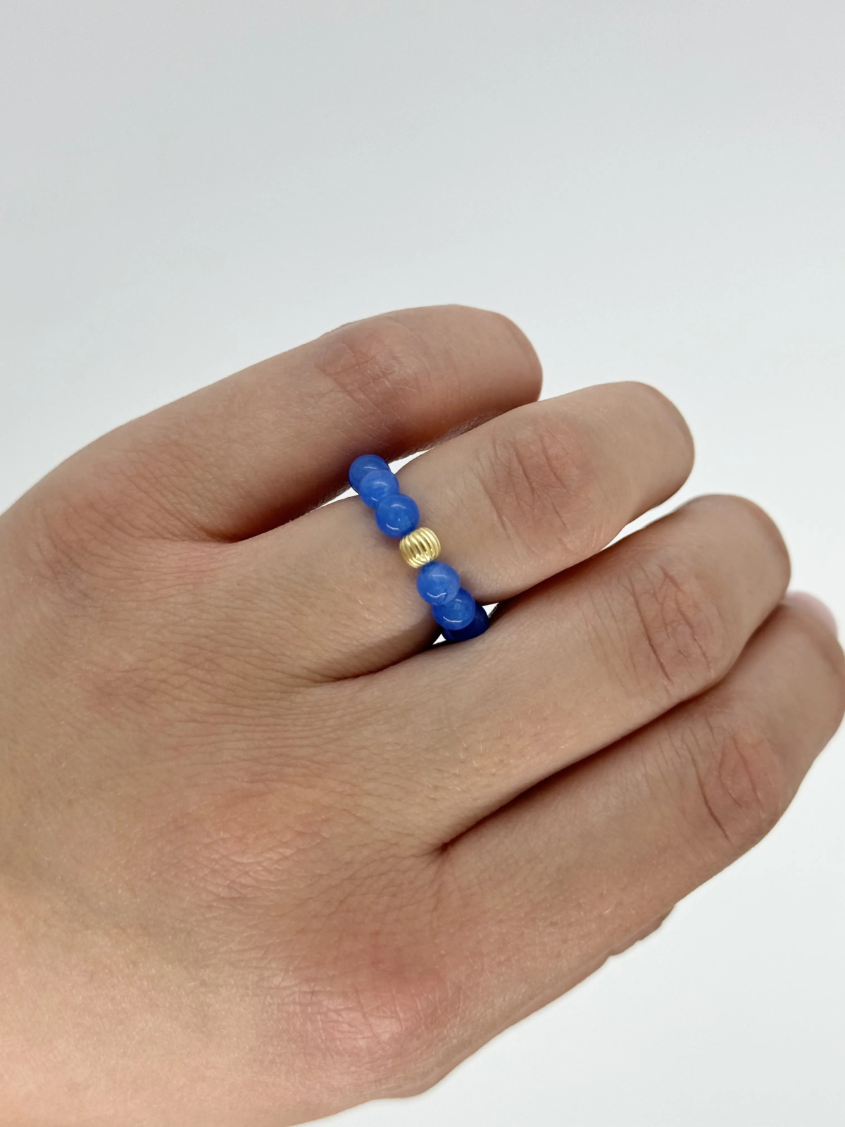 Handmade blue jade stretch ring with a gold-plated 925 silver bead on 0.4 mm cord