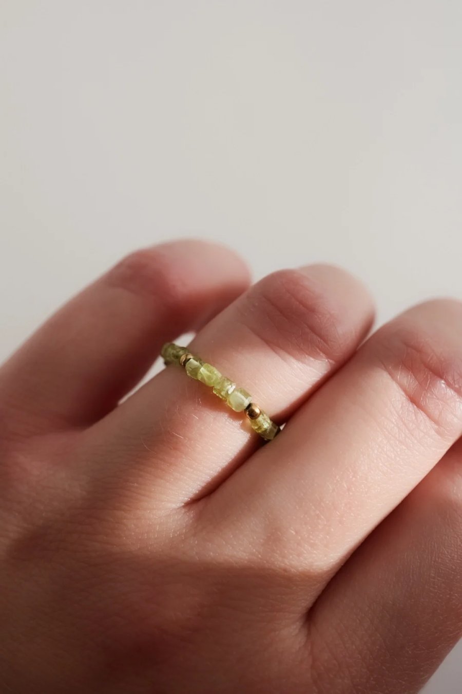 Stretch ring made of tiny peridot and hematite cubes on elastic cord, adjusts to your finger size, handmade