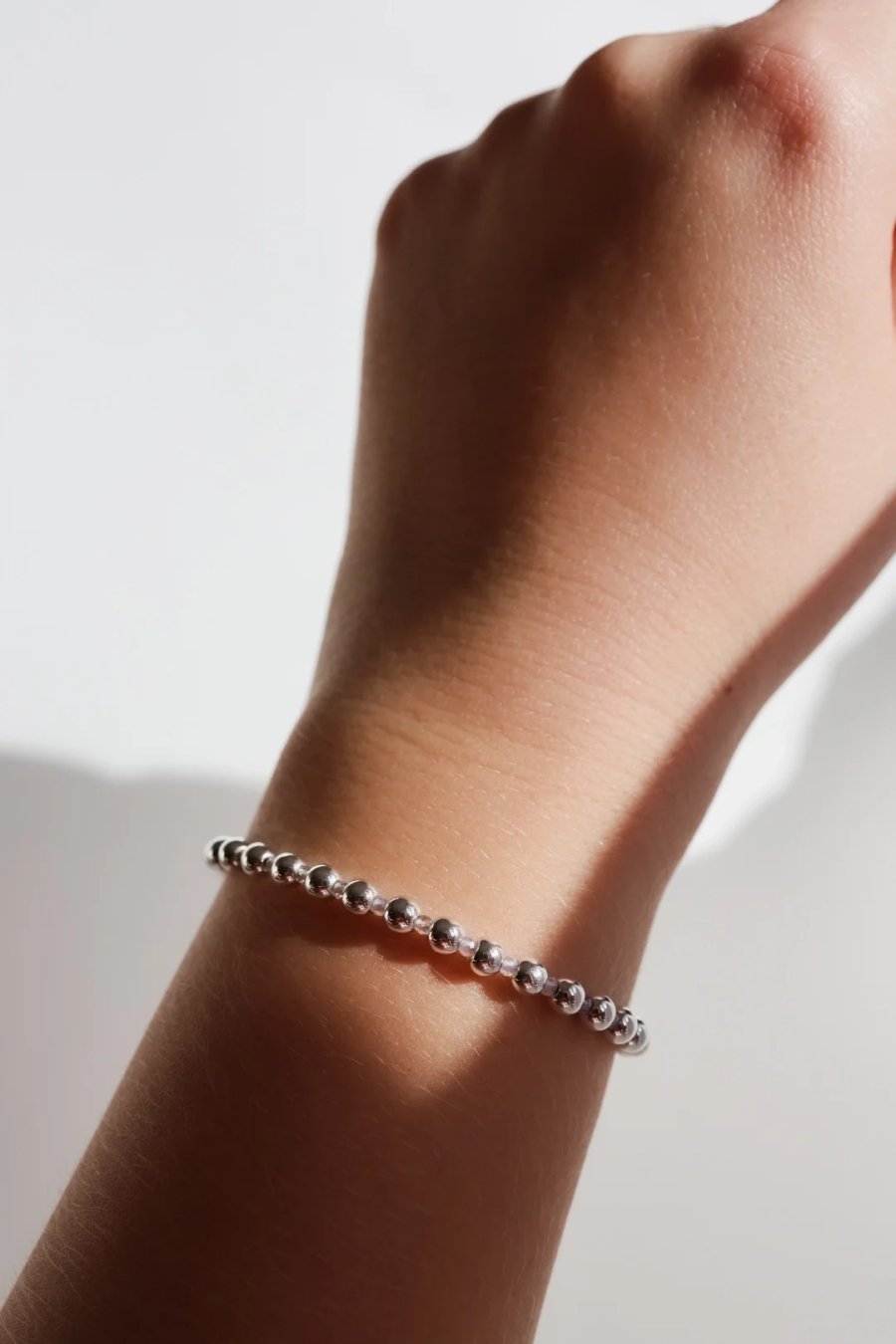 Adjustable silver-plated hematite bracelet with a tiny opal on steel wire, clasp, handmade