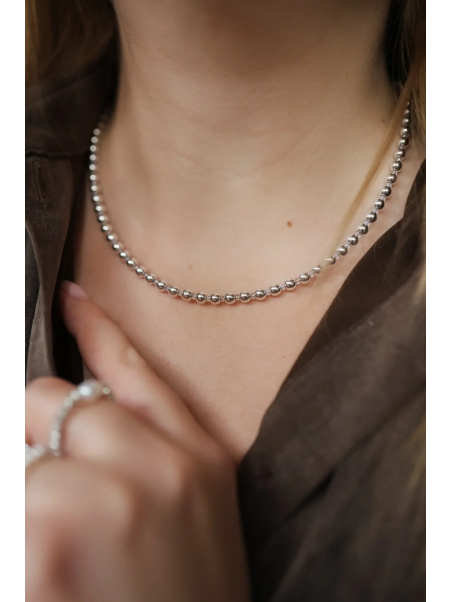 Adjustable necklace of silver-plated hematite and small opal on a steel wire with a clasp of, handmade