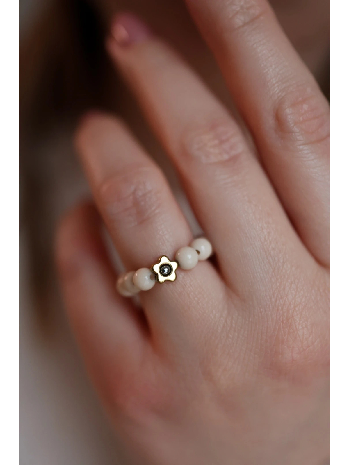 Stretch ring of cream river stones with a two-tone hematite flower — gold and, handmade