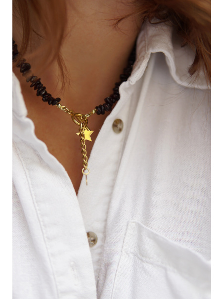 Handmade garnet necklace with star and moon charms on a stainless steel chain